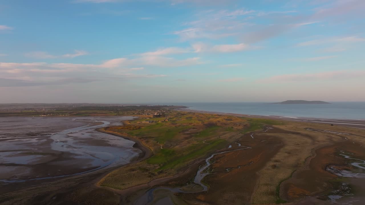 4K cinematic drone footage capturing Malahide Beach, during golden hour, with warm sunset Co.Dublin - Ireland_08