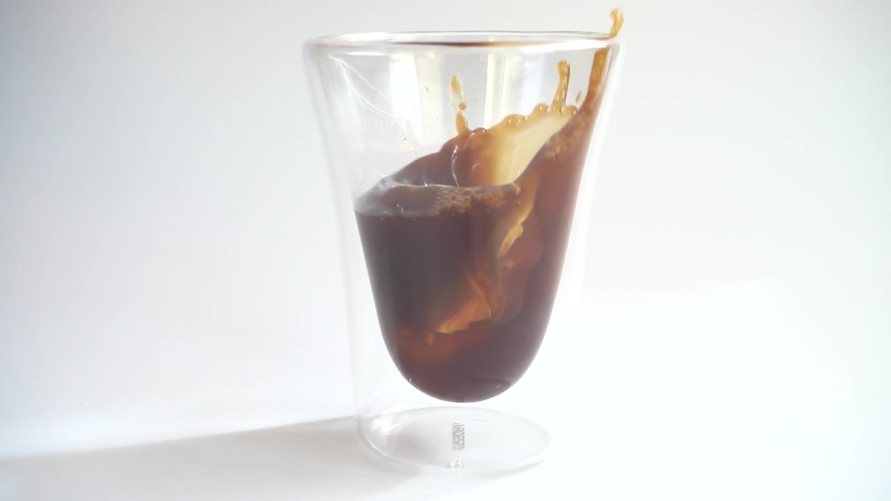 Preparazione di caffè espresso freddo con ghiaccio. Rallentatore.