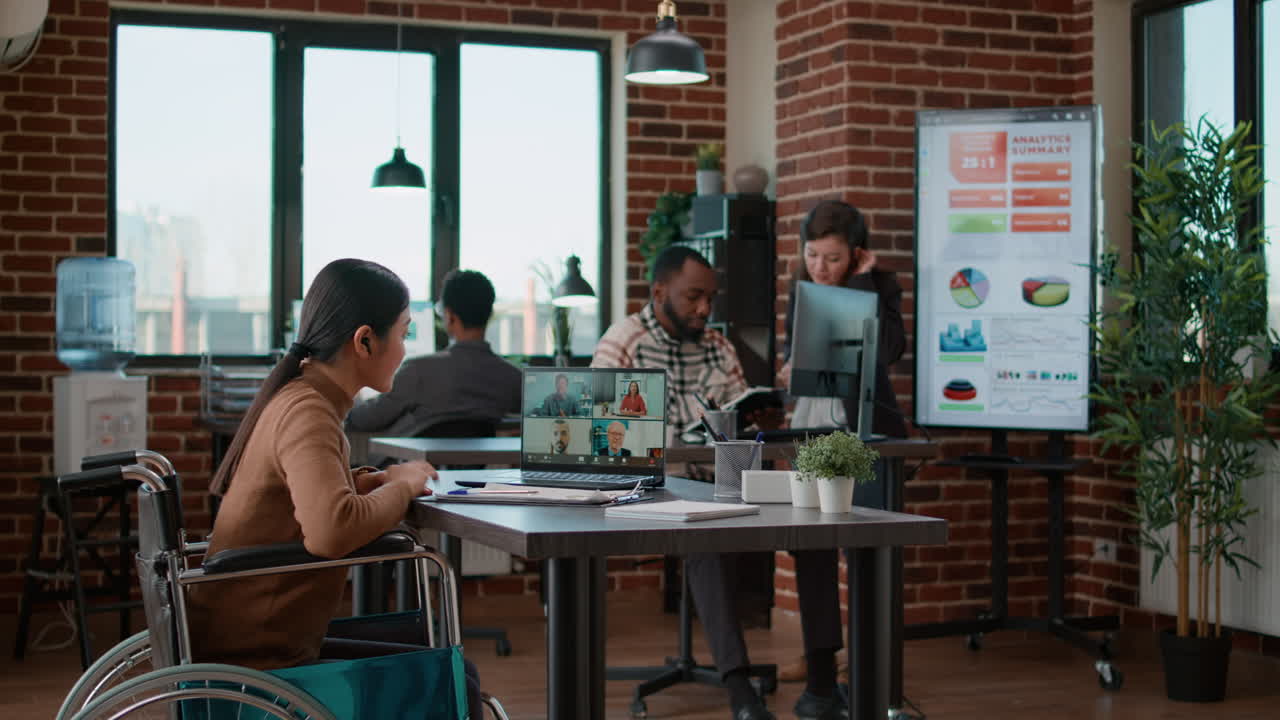 Diverse team of people meeting with woman on videocall