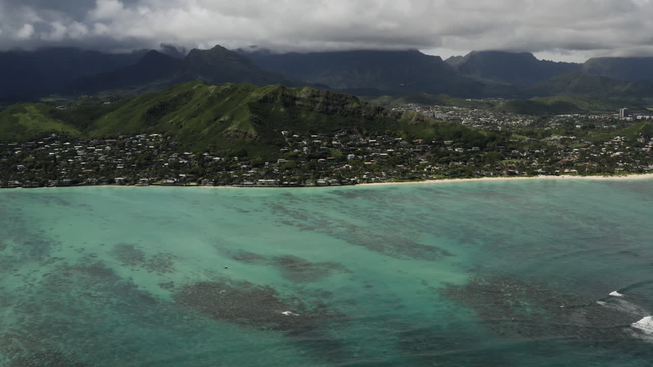 Beautiful aerial view above clear green Oahu ocean water toward Lanikai Beach, Hawaii