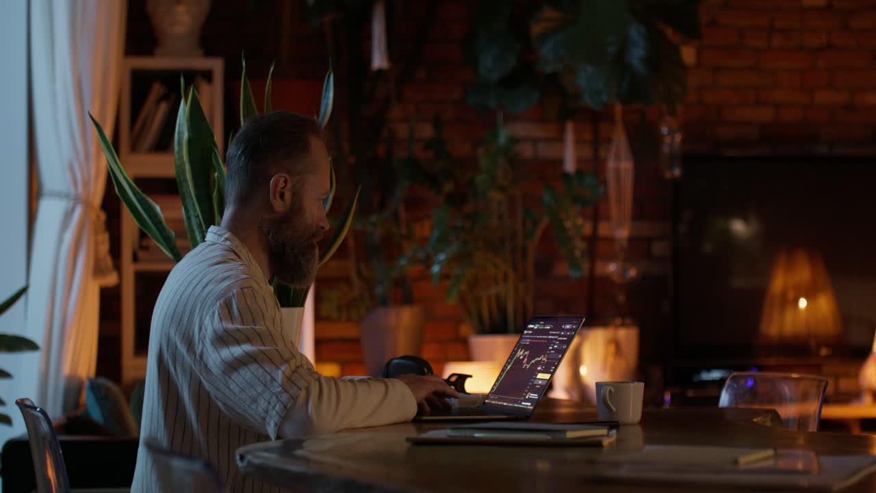 Man Working from Home on Laptop During Evening
