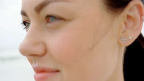 close-up of young caucasian woman standing at beach 4k