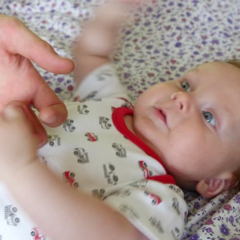 father holding baby hand