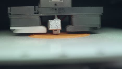 3d printer creating layers on orange object