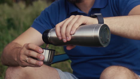 man drinking water outdoors