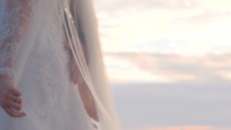 bride and groom near the sea at sunset