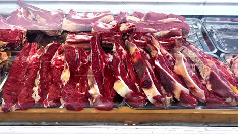 a cutting pieces off a freshly slaughtered sheep in samarkand, uzbekistan