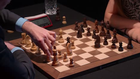 white castles on kings side during opening chess match in tournament with wooden board and pieces and black captures pawn