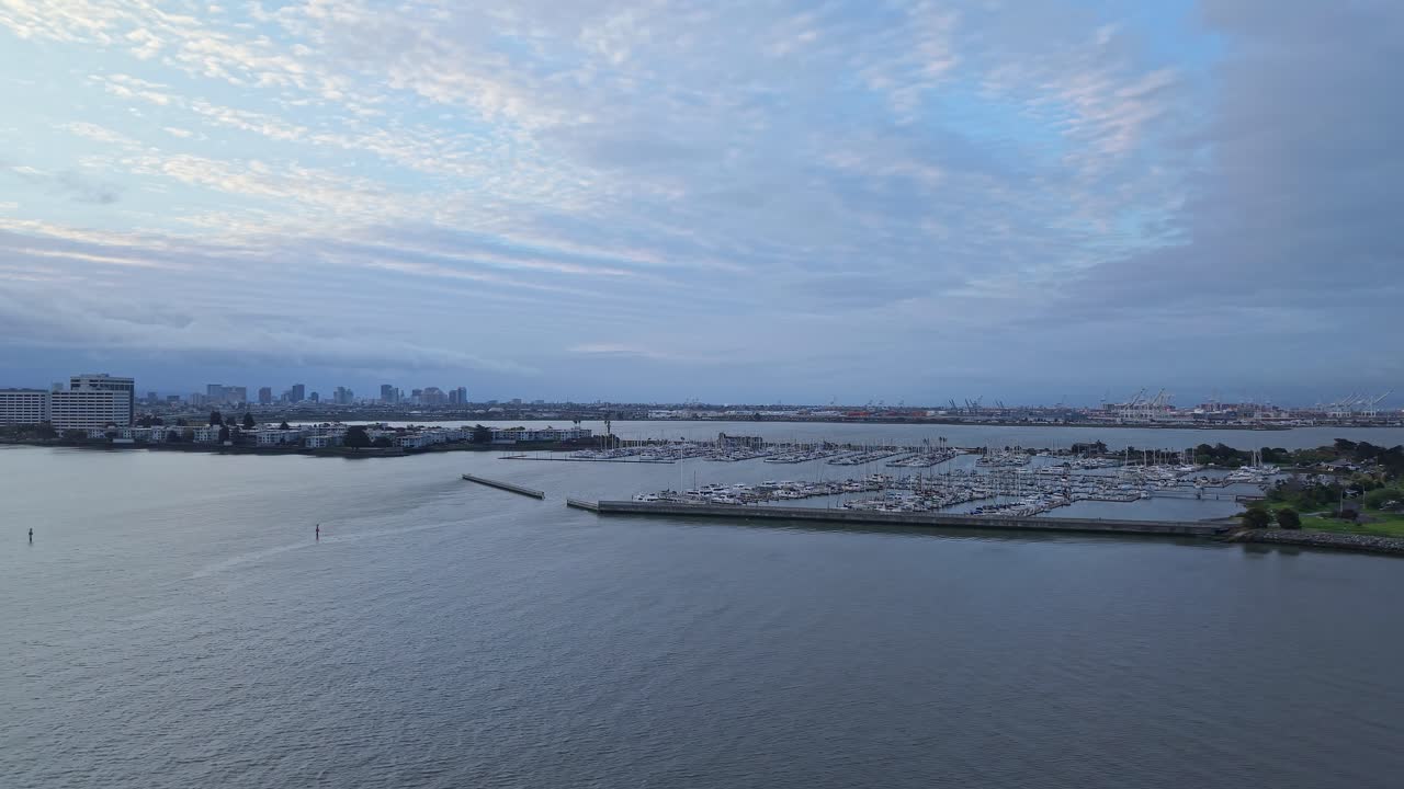 The drone smoothly glides over Emeryville Marina Park, revealing its prime location along the waterfront.