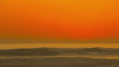 timelapse view of the rising sun over the calm sea horizon