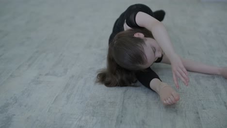 young ballerina practicing dance moves in studio