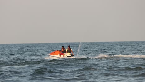 two people riding a jetski across ocean waves.