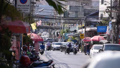 traffic passing through busy street in hua hin, thailand, slow motion