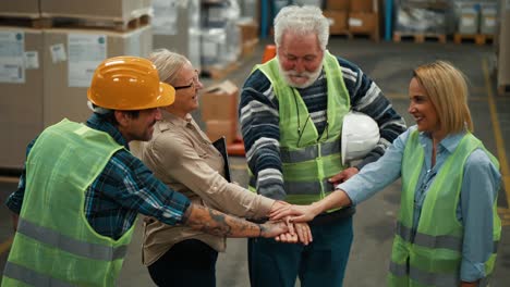 hands of diverse team warehouse workers making a team circle. business success concept. successful team in factory. team building concept.