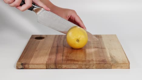 sequential steps of cutting a lemon into slices