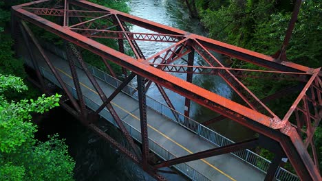 Scenic-aerial-shot-flying-over-bridge-and-flowing-Cedar-River-in-Washington-State