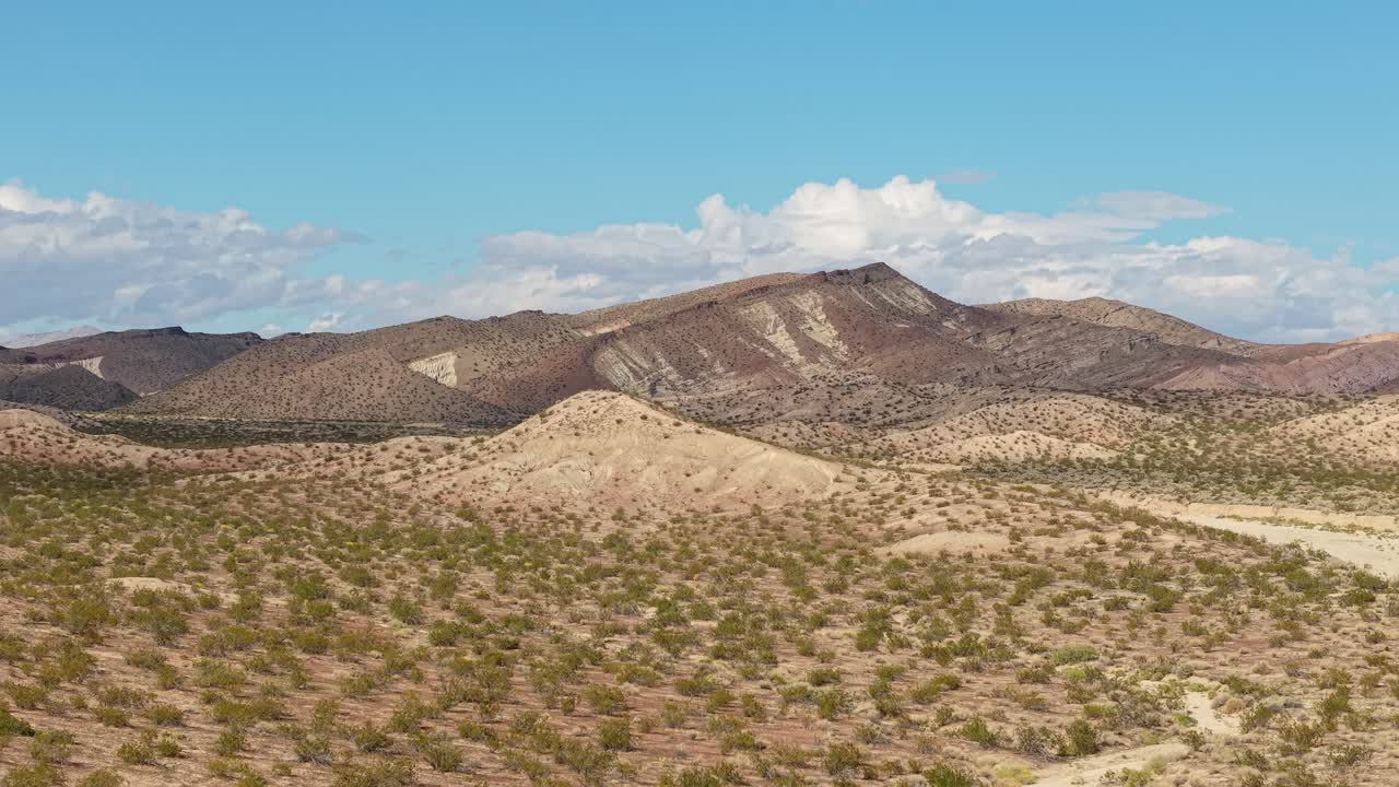 Panning drone views past rugged formations, capturing the earthy desert scenery