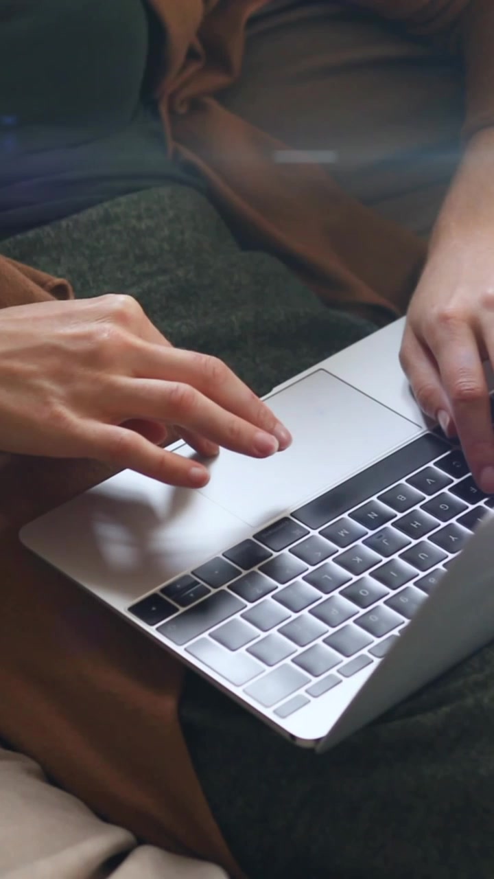 Animation of light and shapes over hands of caucasian woman using laptop