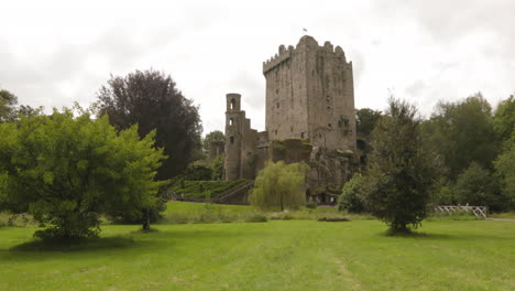 tourist in blarney castle with greenery landscape in blarney near cork, ireland