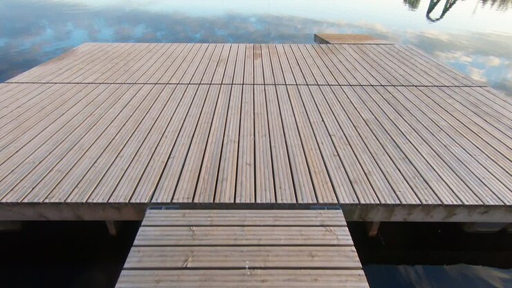 Wooden Pier In The Calm River Water