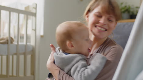 Loving Mom Hugging Happy Baby