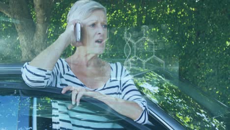 animation of financial data processing over senior caucasian woman talking on smartphone