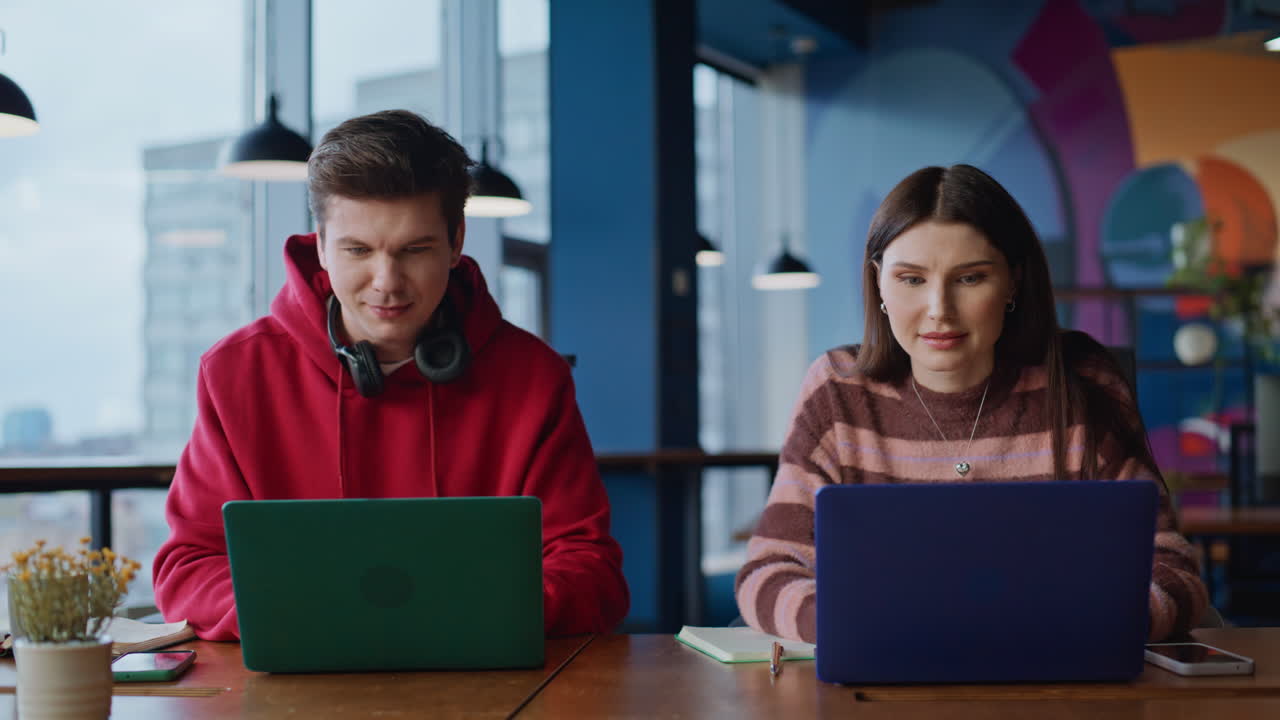 Two colleagues working together and celebrating success