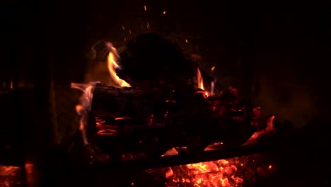 Red-Hot-Fire-with-Wind-Hitting-it-Producing-Flying-Sparks---Slow-Motion-Fireplace