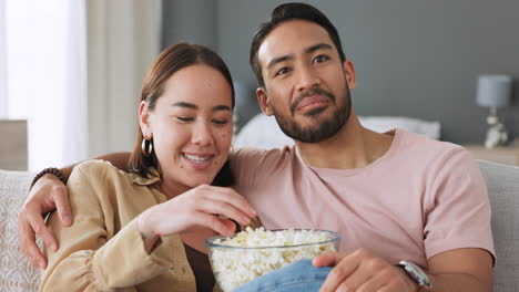 couple in living room, eating popcorn