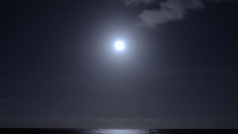 bright full moon over hawaiian ocean with moving stars