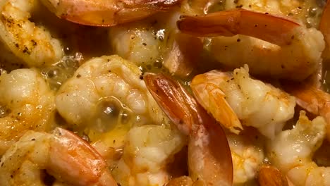 shrimp cooking in butter and seasoning