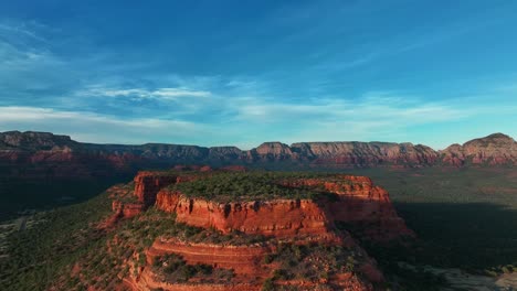 sedona red rock mountain valley against cloudy sky - aerial drone shot