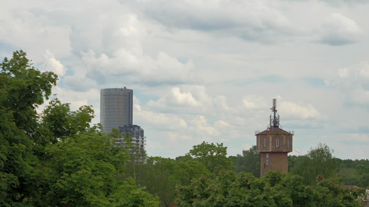 Modern Skyscraper and Water Tower in a City Landscape
