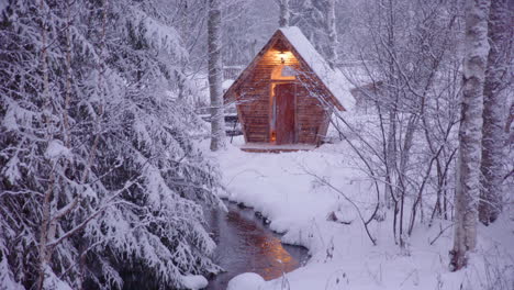 lovers on romantic getaway exit wooden sauna to sit outside in the falling snow