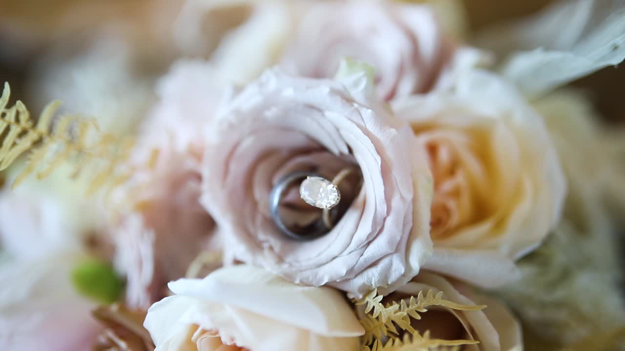 Wedding Rings Placed In Flower Arrangement - Close Up Shot