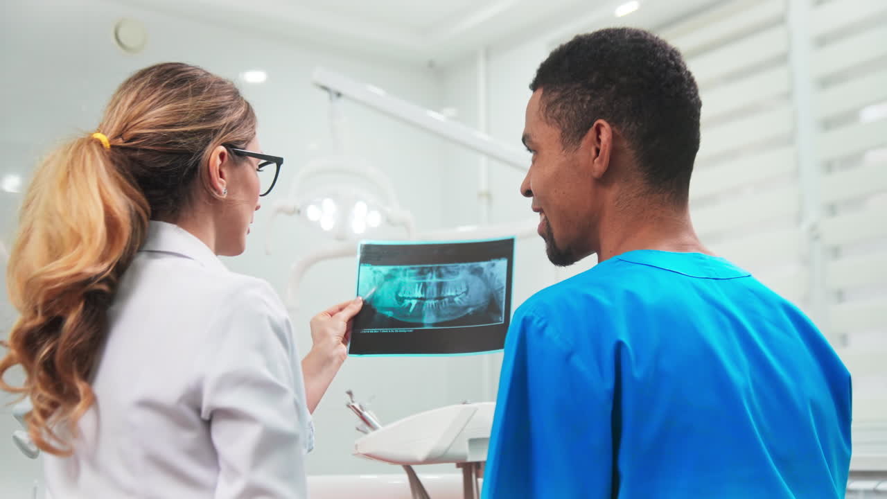 Doctors in the dental office talking and looking at the roentgen image