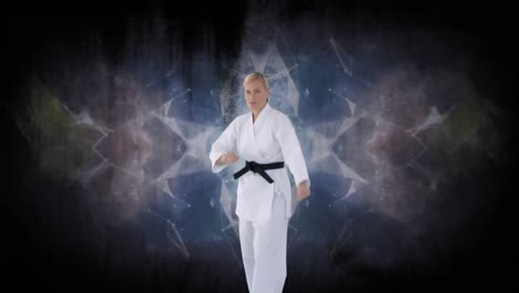 animation of caucasian female martial artist over grey kaleidoscopic moving shapes