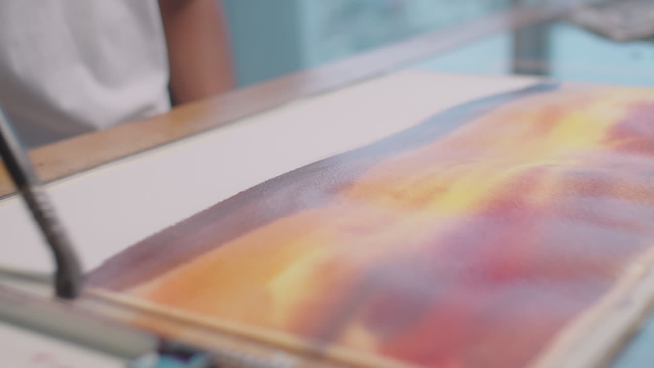 Asian Painter Drawing Picture in Studio