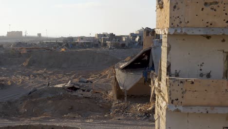 peering around a wall across the war ravaged gaza landscape for any sign of enemy