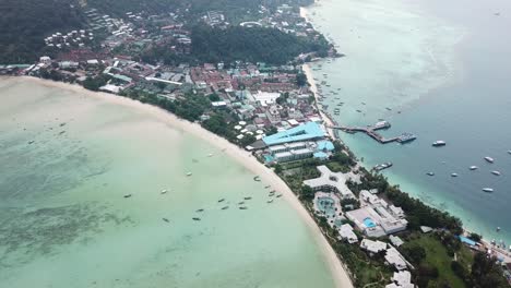 iconic double beach bay on phi phi don island, krabi, thailand, drone aerial view on white sand beaches and residental area between them