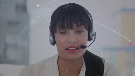 Animation-of-networks-of-connections-over-businesswoman-using-phone-headsets