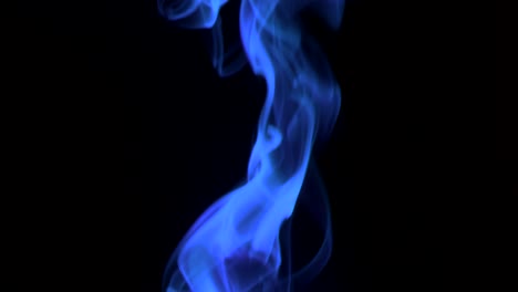 trickle neon-blue smoke slowly rising graceful twists upward. colored smoke blowing from bottom to top. close-up, isolated on black background