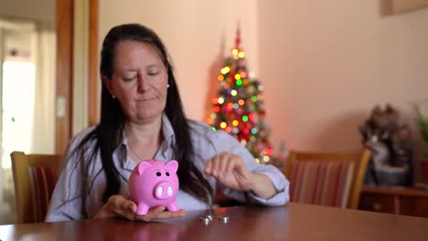 a woman is depositing coins into a piggy bank