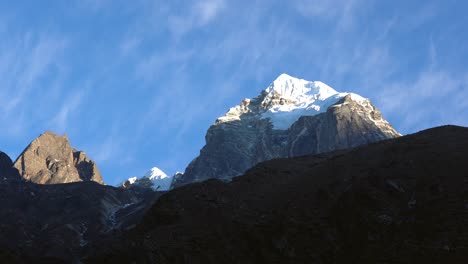 Clouds-slowly-moving-over-the-snow-peak-of-a-mountain-in-the-himalayas