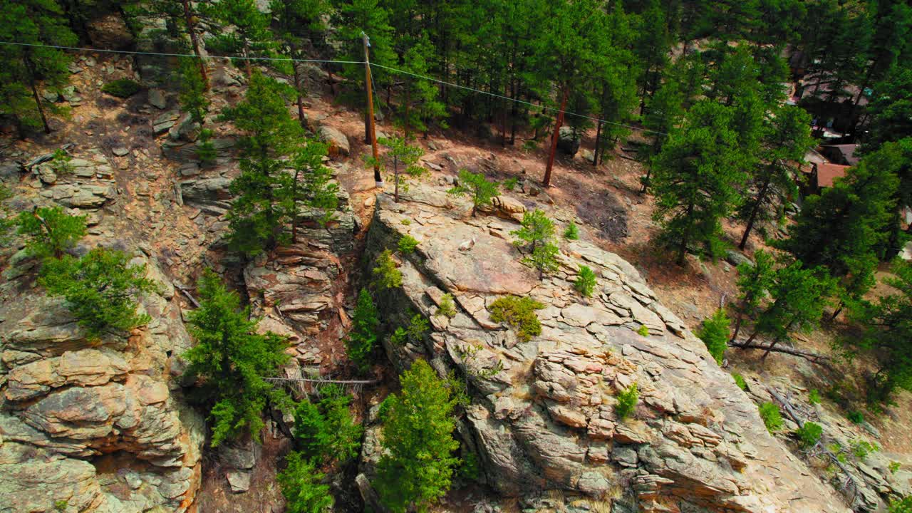 Aerial Footage Of Lonely Mountain Goat On Top Of Rocky Hillside In Colorado Alpine Forest.