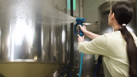 woman cleaning brewing machines