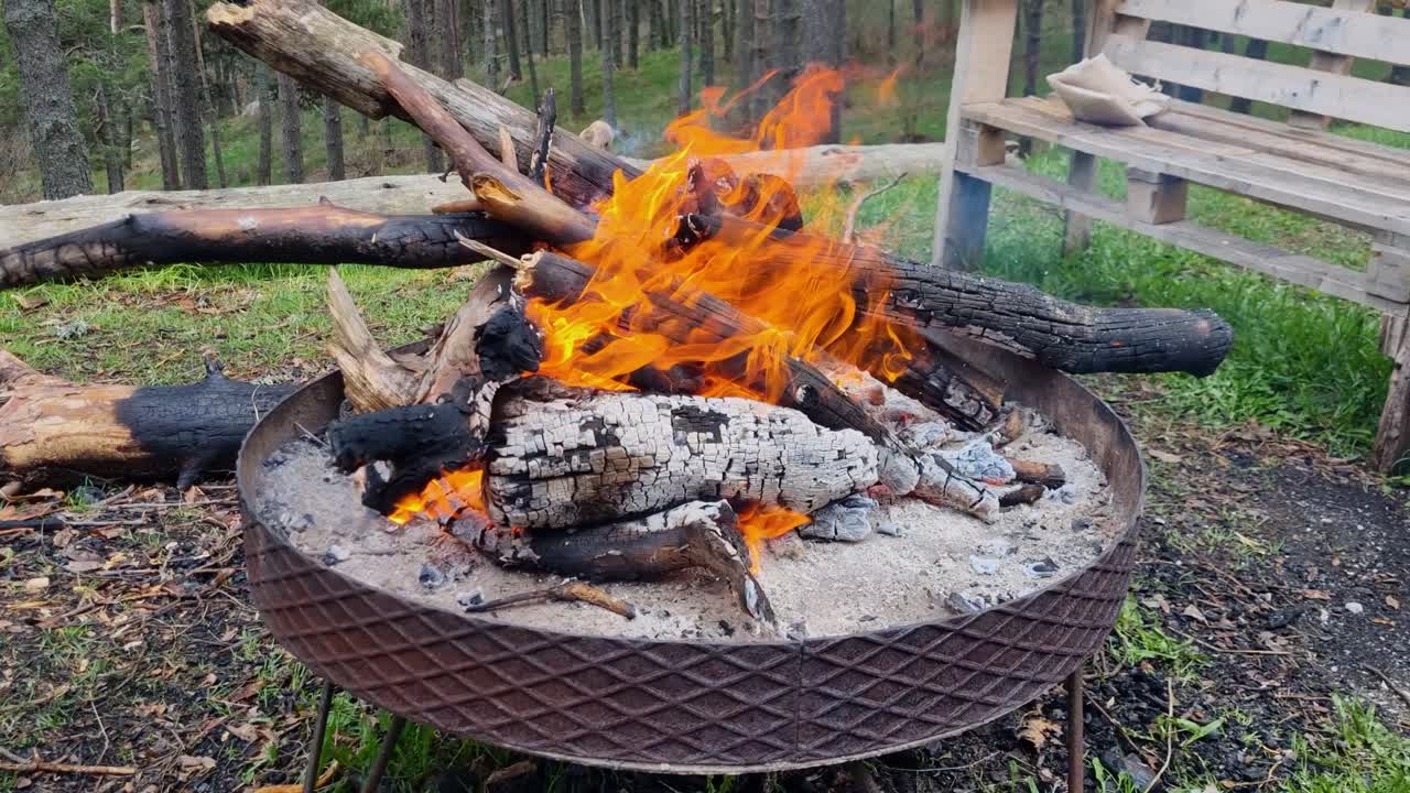 Shot of a campfire burning brightly in the Greek Vrontous mountains near Lailias, with lively flames flickering in the cool mountain air