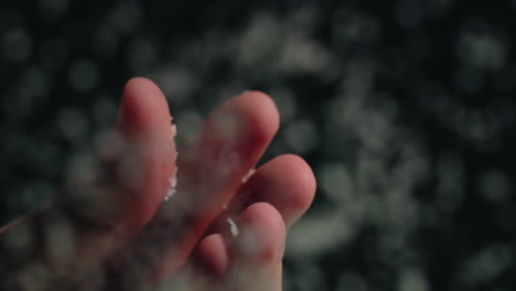 close-up of salt falling from fingers