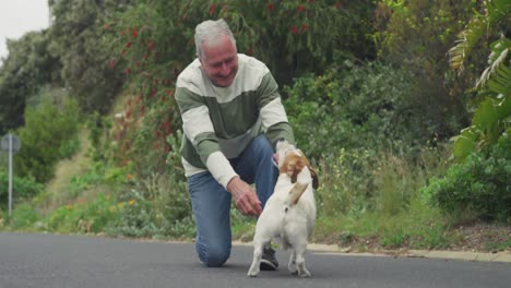 senior man with his dog on the street