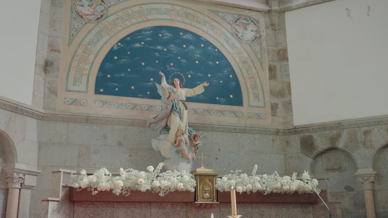 Interior altar with statue and mural inside Santuário de Nossa Senhora da Assunção in Paços de Ferreira, Portugal